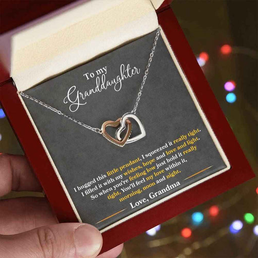 To My Granddaughter, Show her your never-ending loveInterlocking Hearts necklace.
